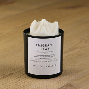  A white soy wax replica candle of Emigrant Peak in a round, black glass.