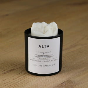  A white soy wax replica candle of Alta mountain in a round, black glass.