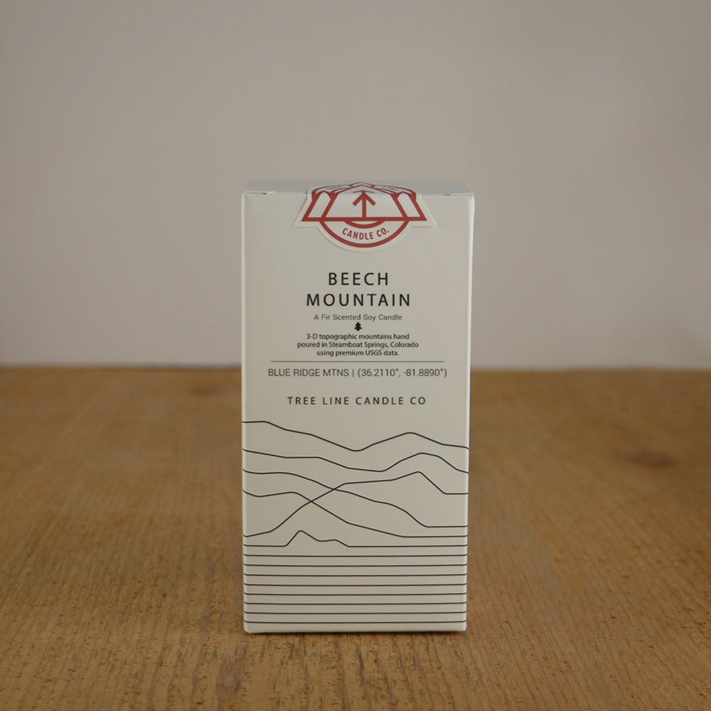 A white box with black lettering and a red and white Tree Line Candle Co.  logo.