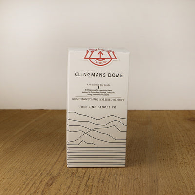 A white box with black lettering and a red and white Tree Line Candle Co.  logo.