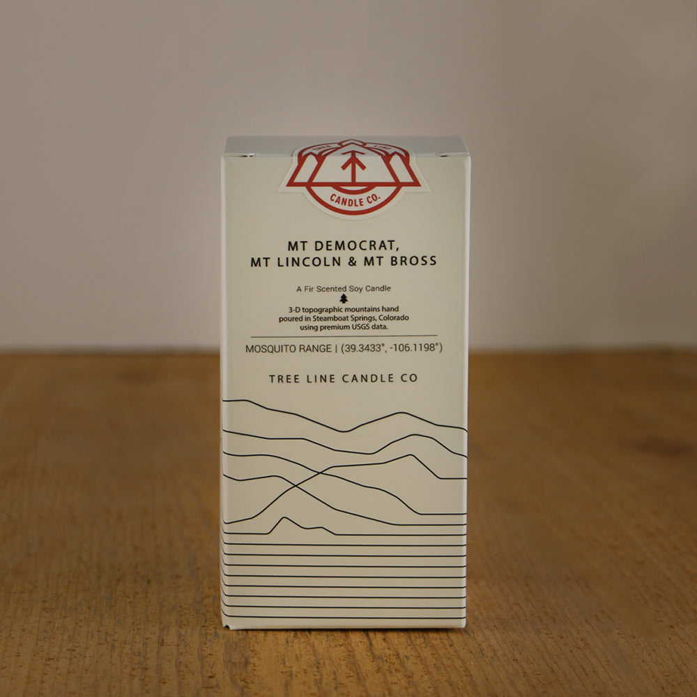 A white box with black lettering and a red and white Tree Line Candle Co.  logo.
