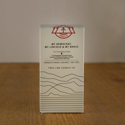 A white box with black lettering and a red and white Tree Line Candle Co.  logo.