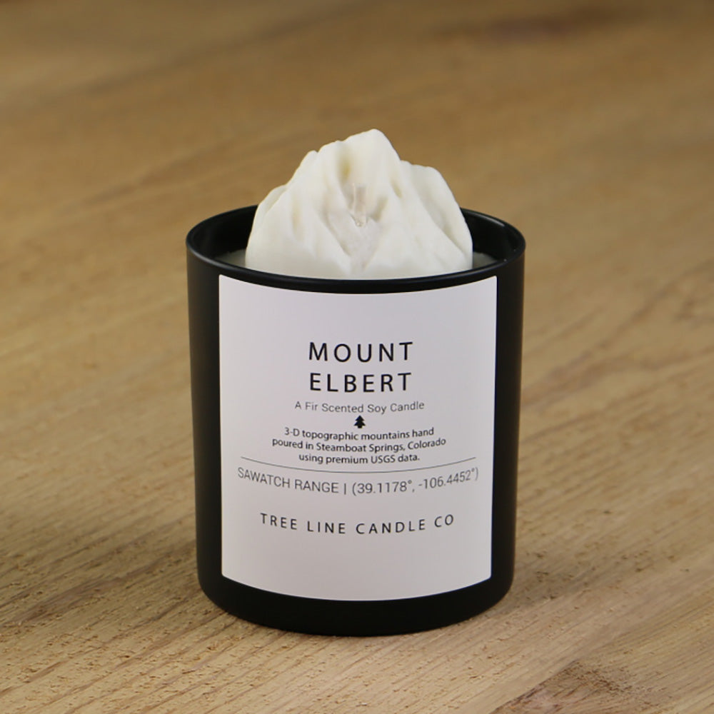  A white soy wax replica candle of Mount Elbert in a round, black glass.
