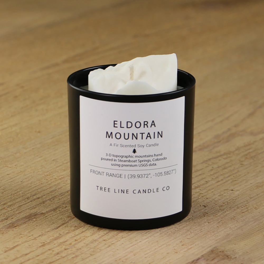  A white soy wax replica candle of Eldora Mountain in a round, black glass.