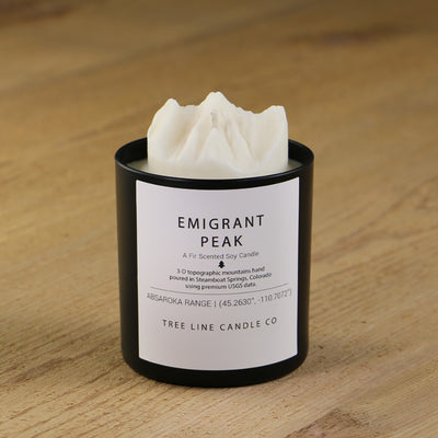  A white soy wax replica candle of Emigrant Peak in a round, black glass.