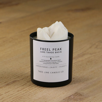  A white soy wax replica candle of Freel Peak Lake Tahoe Basin in a round, black glass.