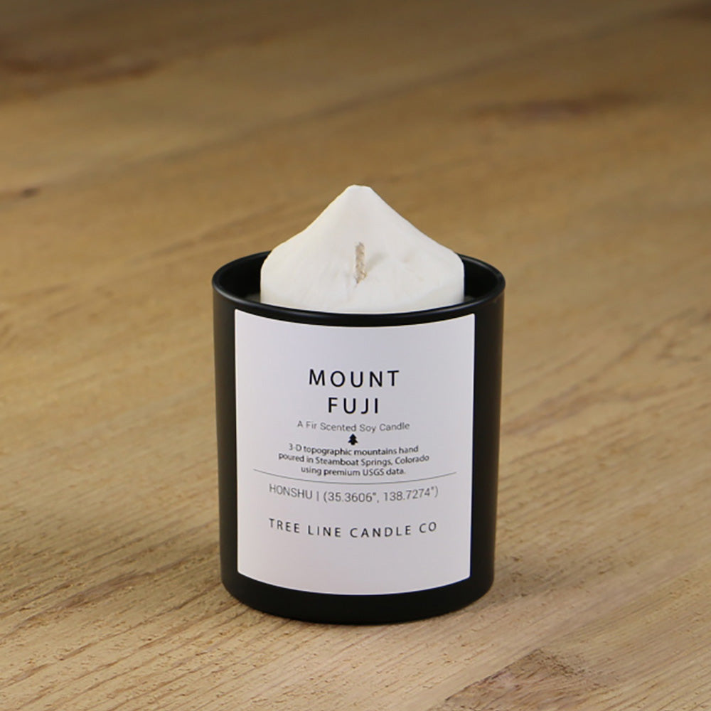  A white soy wax replica candle of Mount Fuji in a round, black glass.