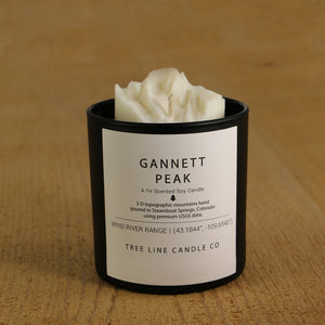  A white soy wax replica candle of Gannett Peak in a round, black glass.