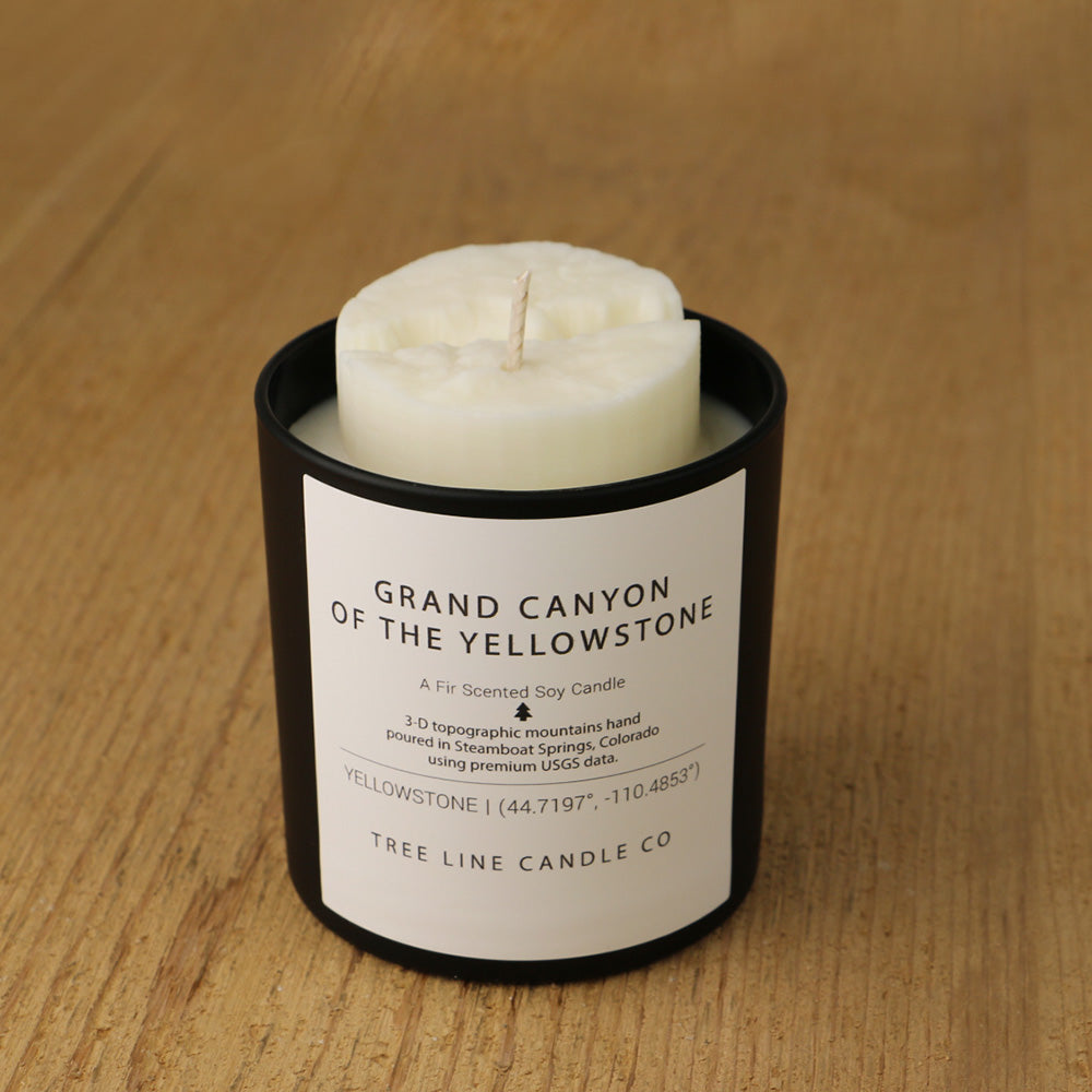  A white soy wax replica candle of Grand Canyon in a round, black glass