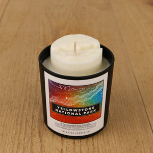  A white soy wax replica candle of Grand Canyon in a round, black glass.