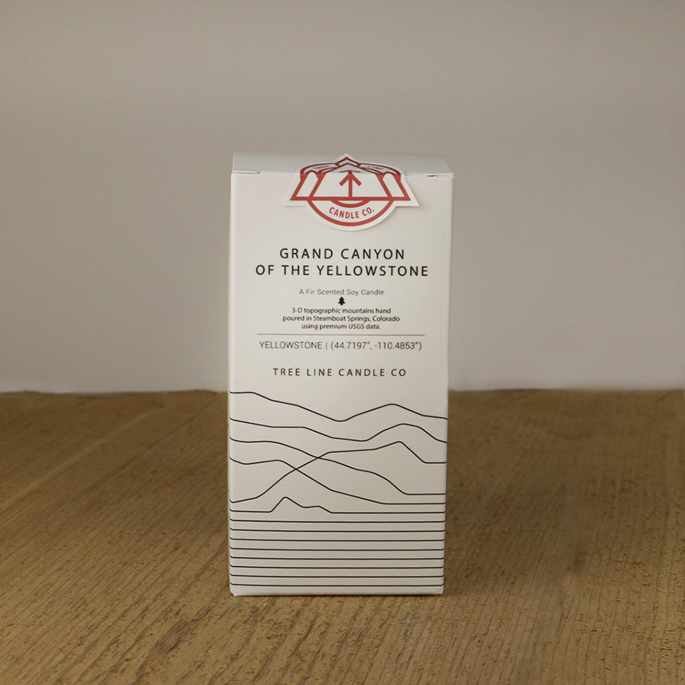 A white box with black lettering and a red and white Tree Line Candle Co.  logo.