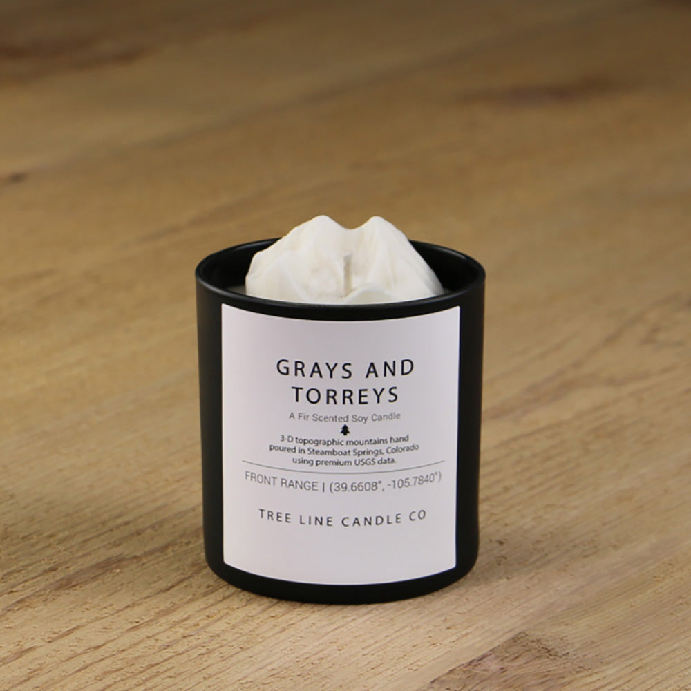  A white soy wax replica candle of Grays and Torreys peak in a round, black glass.