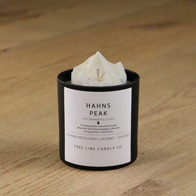  A white soy wax replica candle of Hahns Peak in a round, black glass.