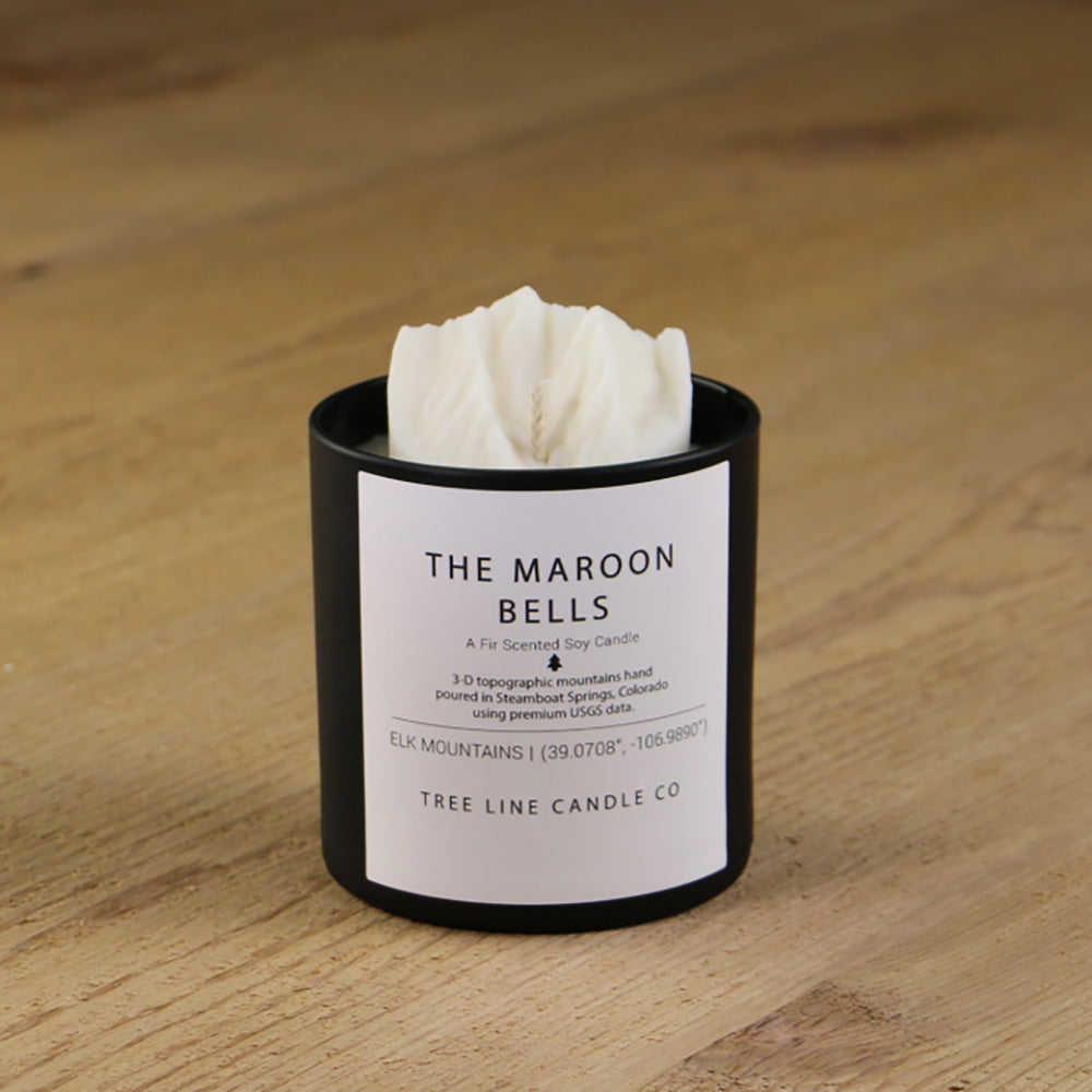  A white soy wax replica candle of The Maroon Bells in a round, black glass.