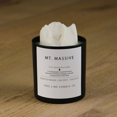  A white soy wax replica candle of Mt. Massive in a round, black glass.