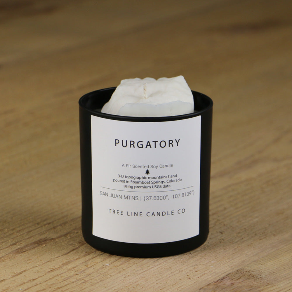  A white soy wax replica candle of Purgatory in a round, black glass.