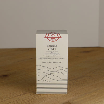 A white box with black lettering and a red and white Tree Line Candle Co.  logo.