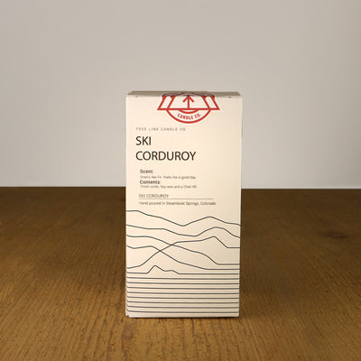 A white box with black lettering and a red and white Tree Line Candle Co.  logo.