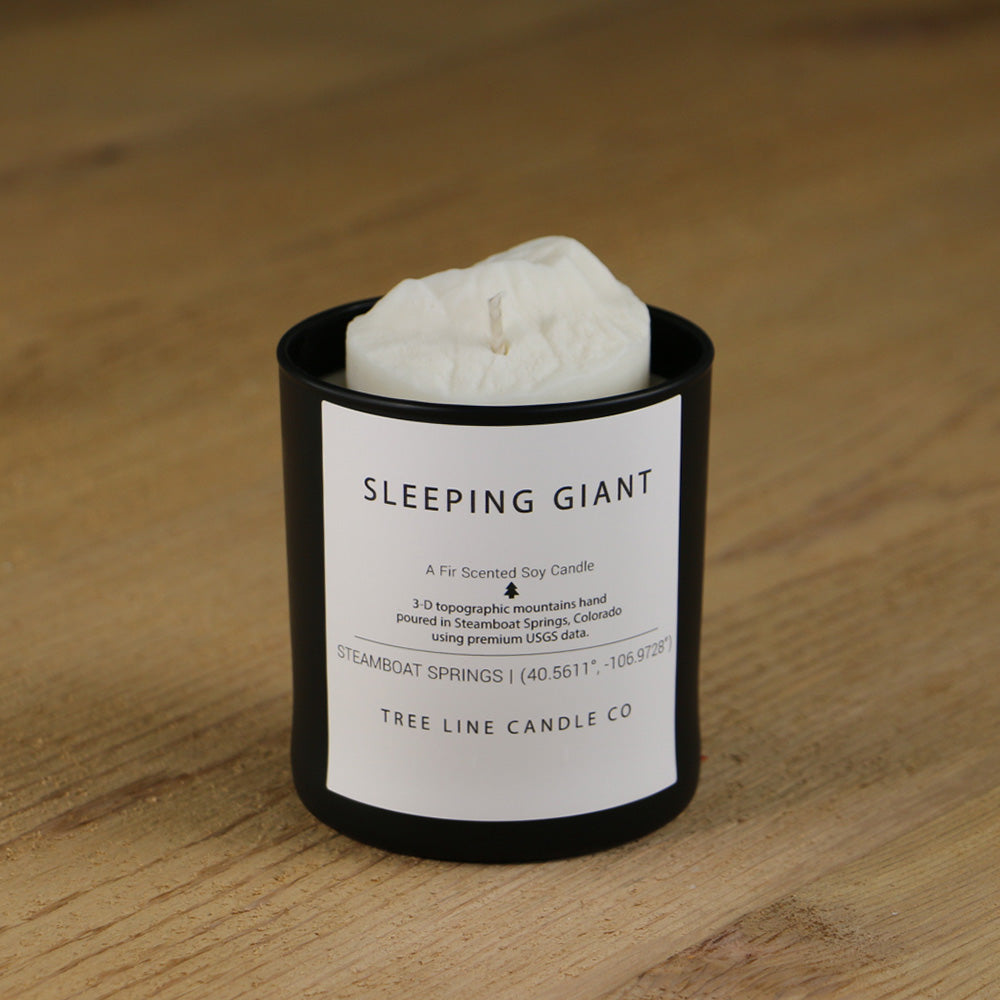  A white soy wax replica candle of Sleeping Giant in a round, black glass.