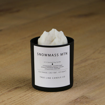  A white soy wax replica candle of Snowmass Mountain in a round, black glass.