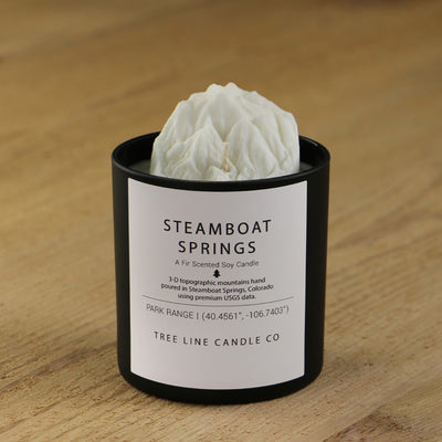  A white soy wax replica candle of Steamboat Springs in a round, black glass.