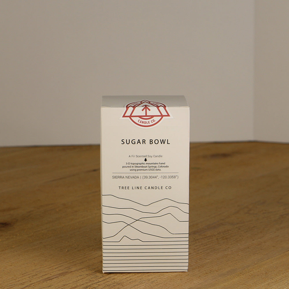 A white box with black lettering and a red and white Tree Line Candle Co.  logo.