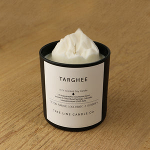  A white soy wax replica candle of Targhee mountain in a round, black glass.