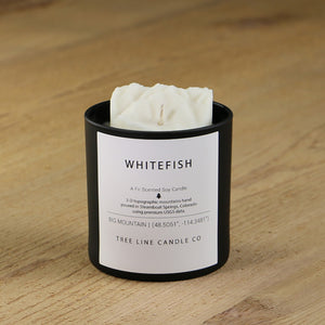  A white soy wax replica candle of Whitefish mountain in a round, black glass.